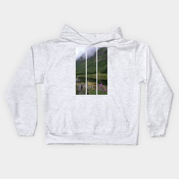 Wonderful landscapes in Norway. Senja, Nordland. Beautiful scenery of a valley with lupine flowers on the rocks. Mirror in the lake. Cloudy summer day. Fog and mountains in background (vertical) Kids Hoodie by fabbroni-art